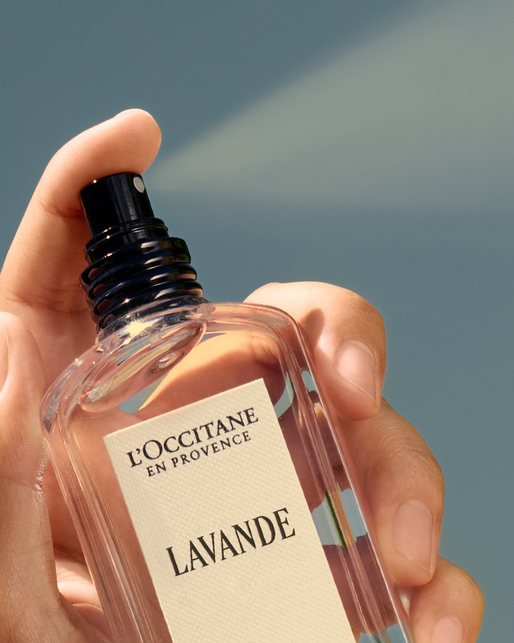 Hand holding a bottle of L'Occitane Lavender Eau de Toilette